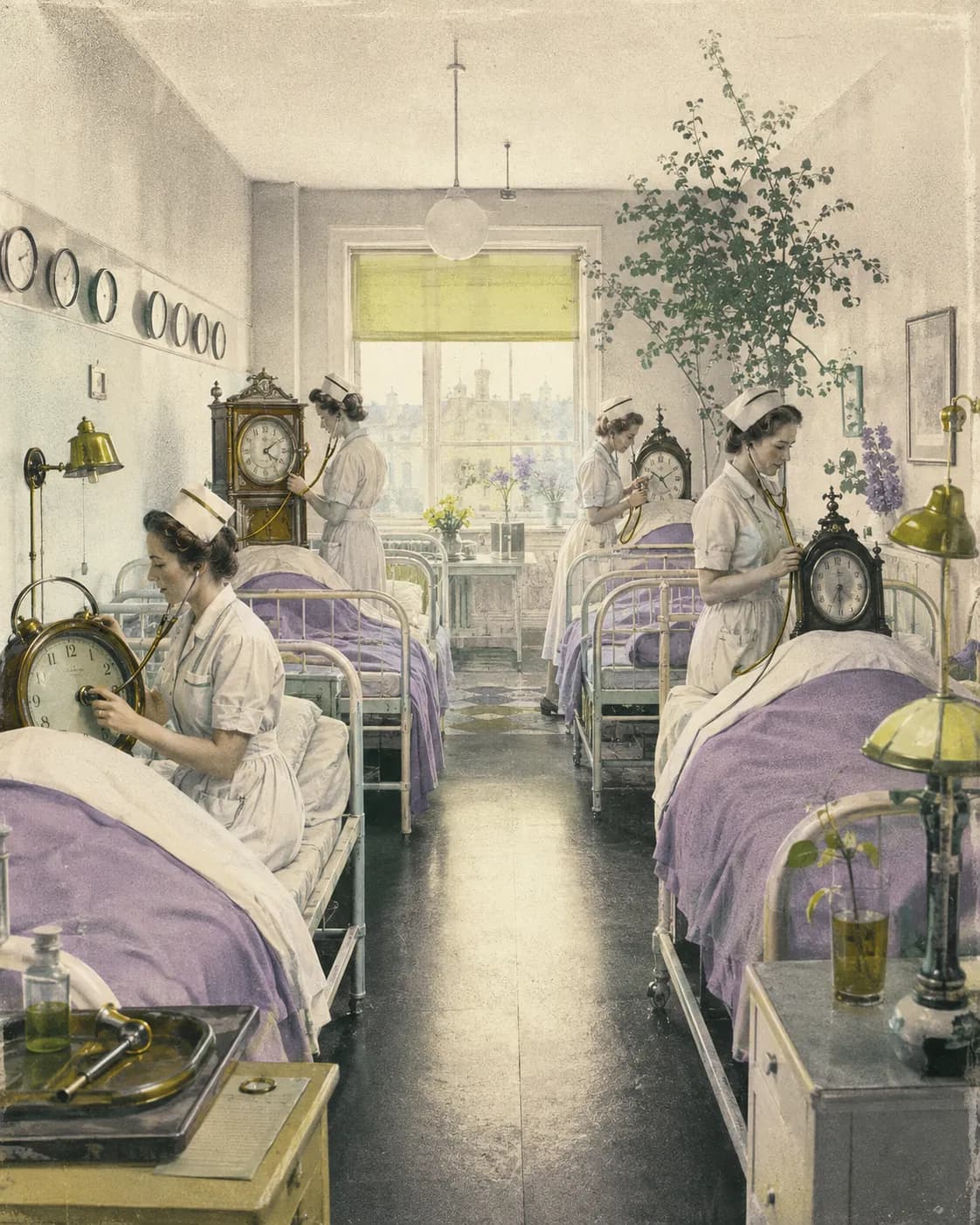 Nurses using stethoscopes to examine clocks resting in beds in a bright hospital ward.